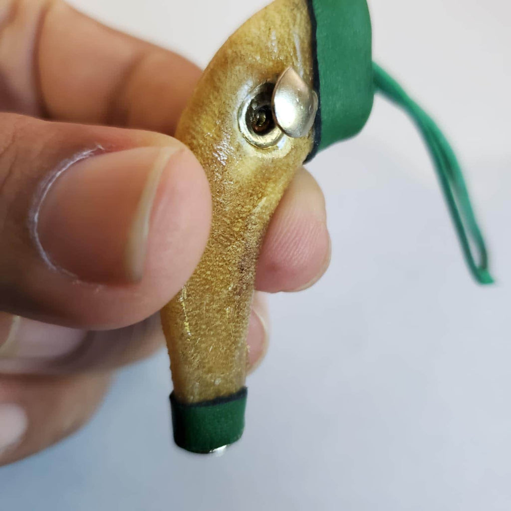 Short scabbard, rawhide, rubber band fastener  Mexican short scabbard, rawhide with rubber band fastener.