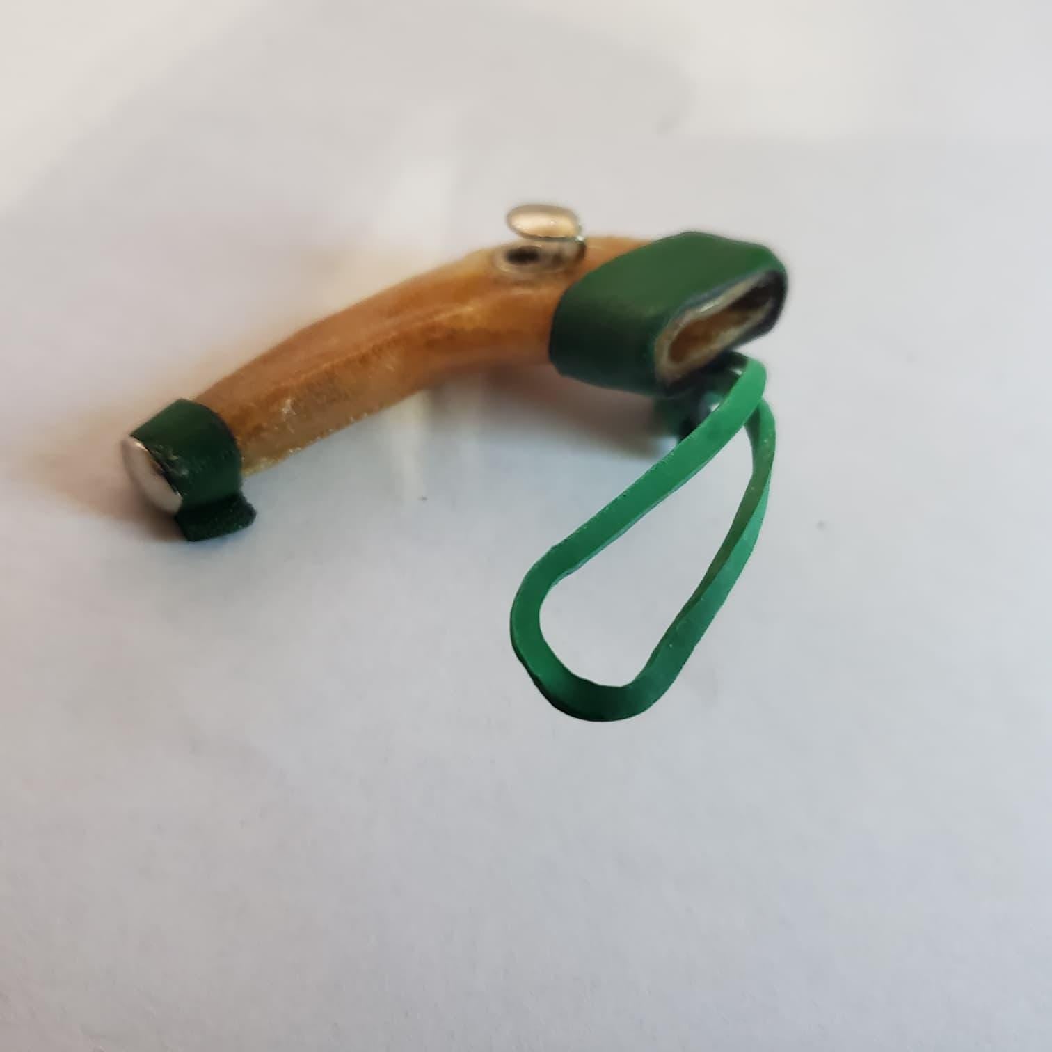 Short scabbard, rawhide, rubber band fastener  Mexican short scabbard, rawhide with rubber band fastener.